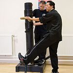 master kwok shows how to kick through the knee