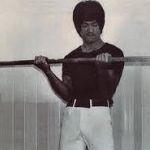 bruce lee with barbell weights.jpg